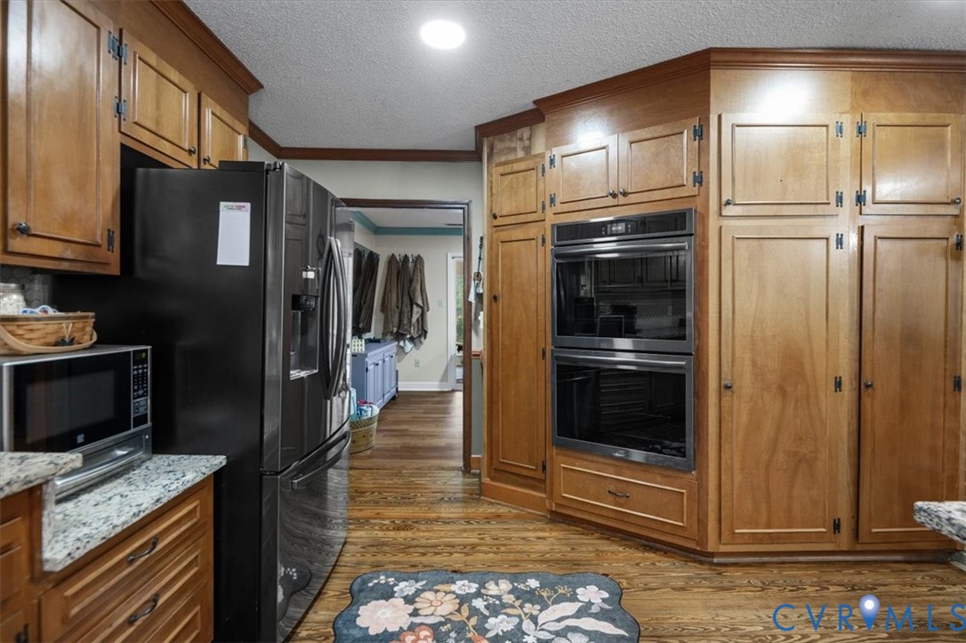 18522 Goode Lane Dinwiddie, VA 23841 - Photo 18 of 99 a kitchen with stainless steel appliances kitchen island granite countertop a refrigerator and a stove top oven