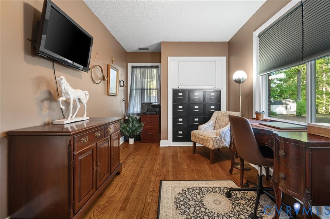 18522 Goode Lane Dinwiddie, VA 23841 - Photo 29 of 99 a living room with furniture a flat screen tv and a floor to ceiling window