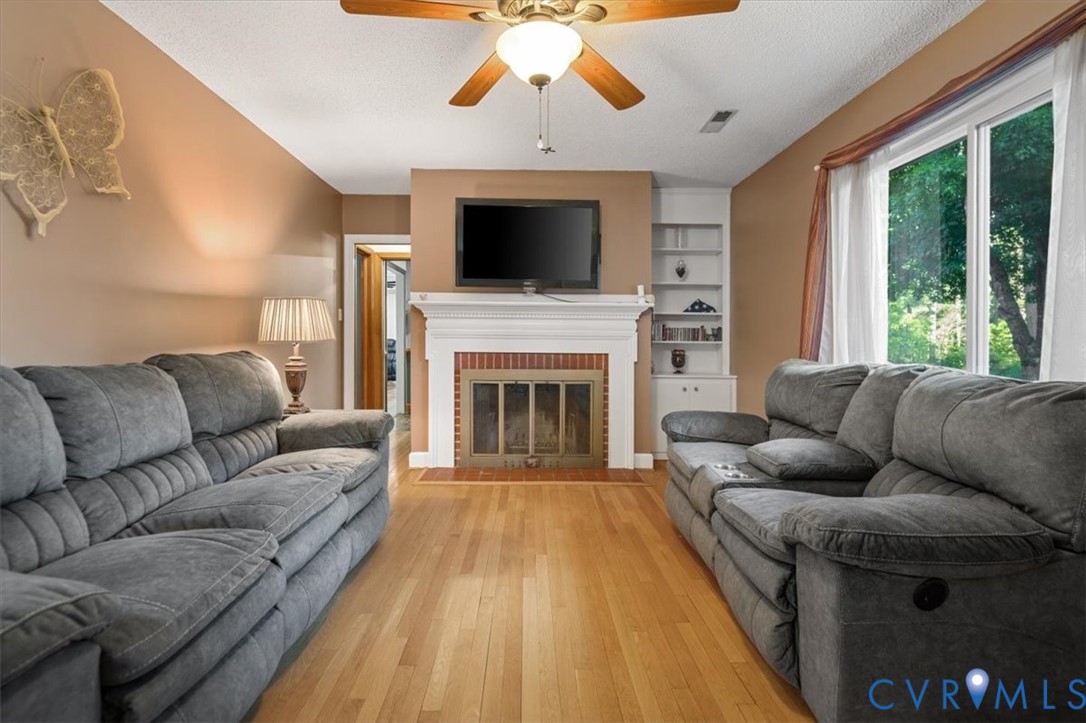 18522 Goode Lane Dinwiddie, VA 23841 - Photo 32 of 99 a living room with furniture a large window and a fireplace