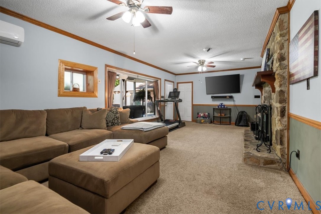 18522 Goode Lane Dinwiddie, VA 23841 - Photo 45 of 99 a living room with furniture a flat screen tv and a fireplace