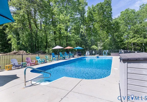 swimming pool view with a seating space