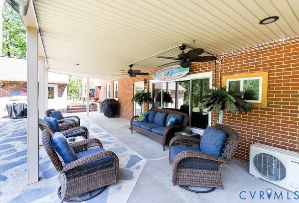 a outdoor living space with furniture and a flat screen tv