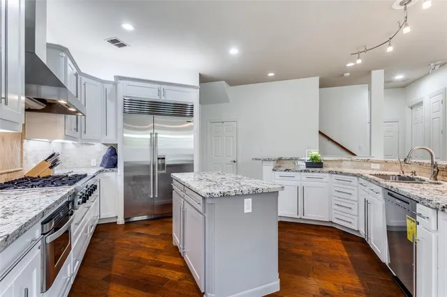 a kitchen with stainless steel appliances granite countertop a stove and a sink