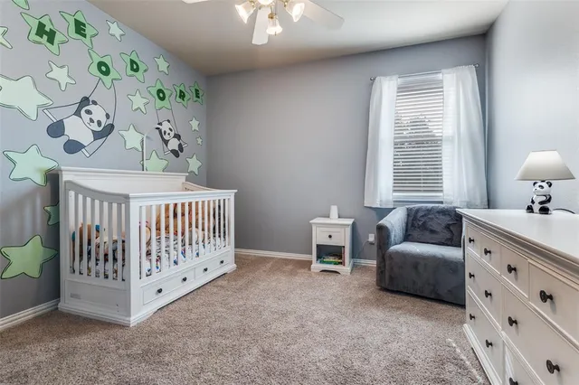a bed sitting in a bedroom next to a book shelf