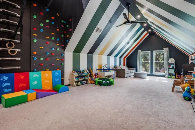 a view of play room with chairs and toys