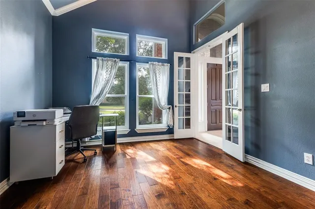 a dining room with furniture a chandelier and wooden floor