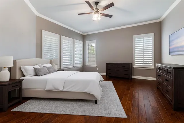 a spacious bathroom with a double vanity sink a large mirror a bathtub and next to a window