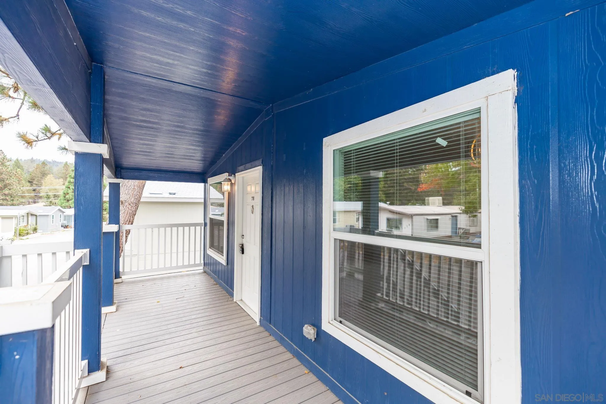 22899 Byron Road, Unit SPC 78 Crestline, CA 92325 - Photo 19 of 28 a view of a hallway with wooden floor and windows