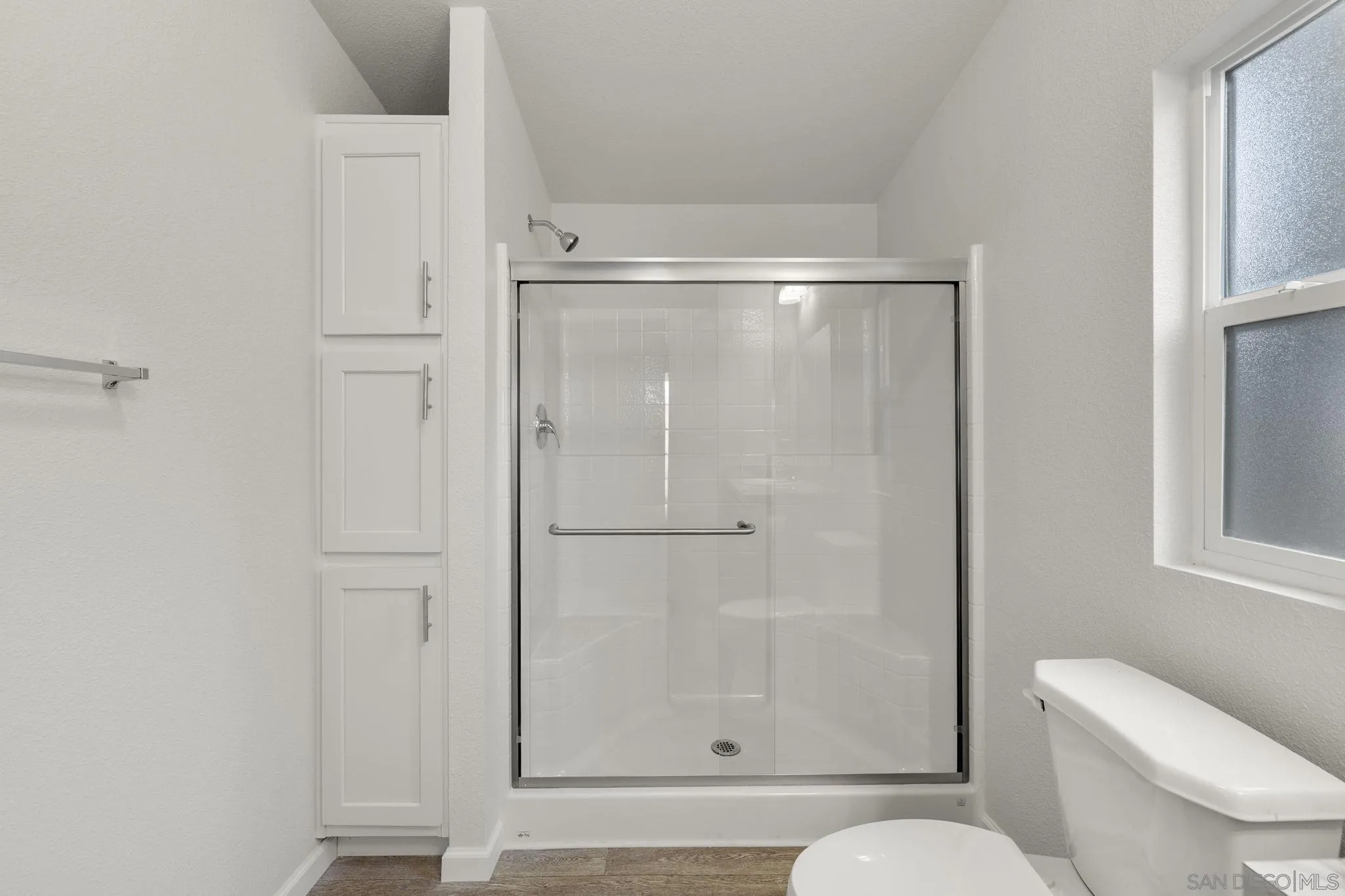 22899 Byron Road, Unit SPC 78 Crestline, CA 92325 - Photo 26 of 28 a bathroom with a shower a toilet and a window