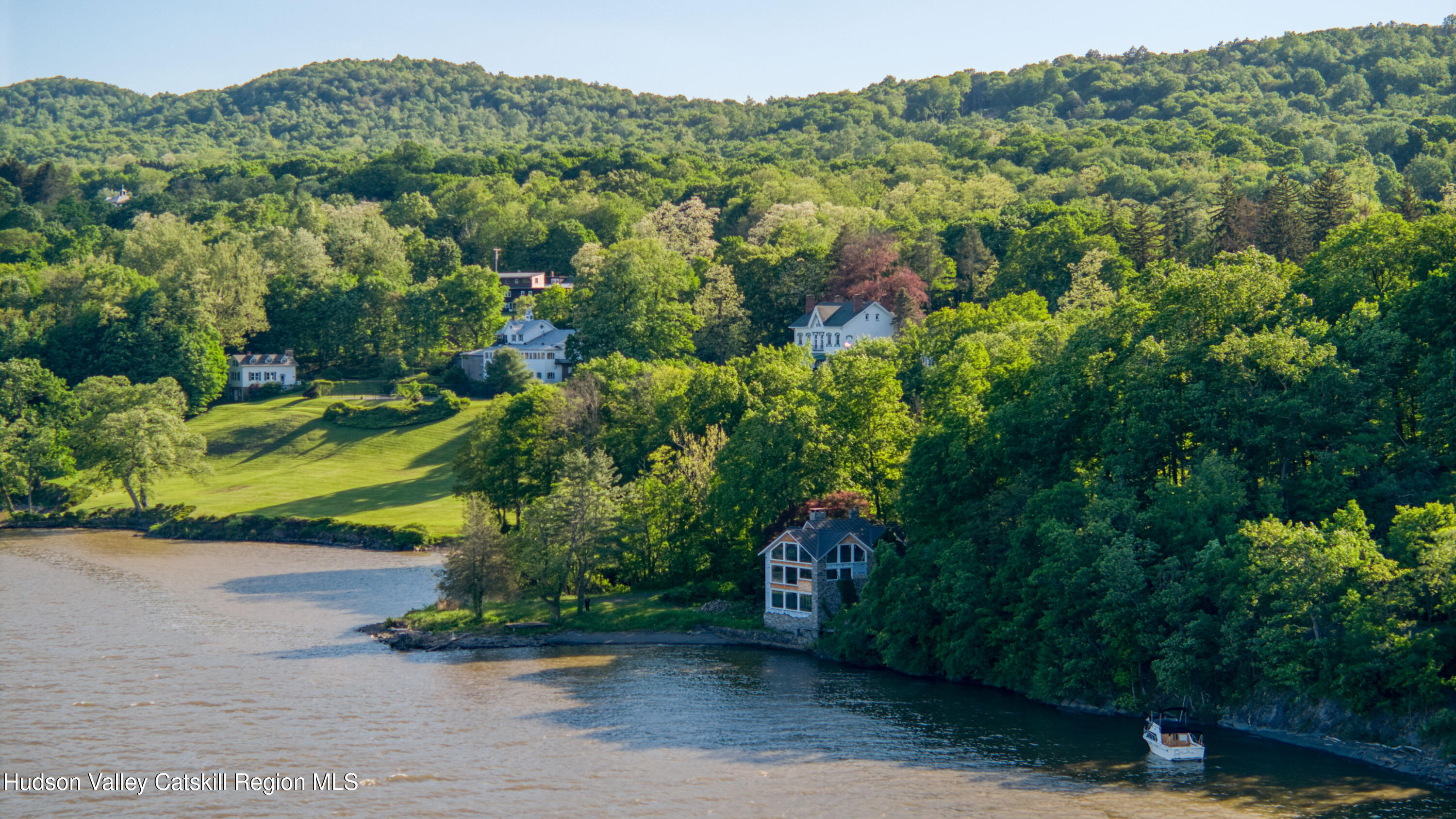 an aerial view of a house with a yard
