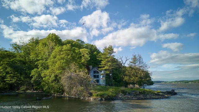 a view of a lake with houses in back