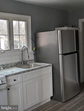 a kitchen with appliances a window and a sink