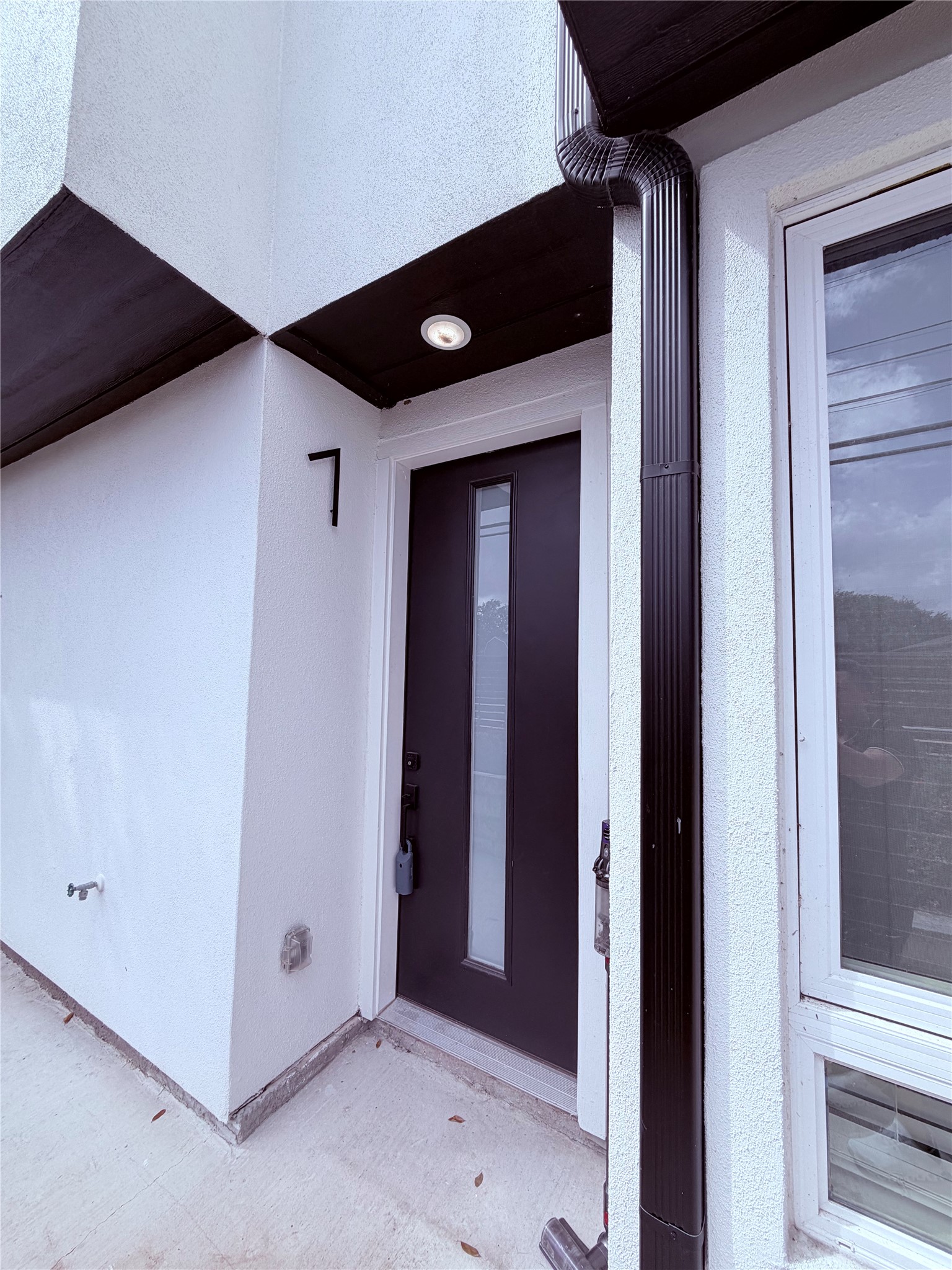 1417 Kramer Lane, Unit 7 Austin, TX 78758 - Photo 2 of 24 A modern black entry door invites you into this sleek, contemporary residence.