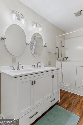 a bathroom with a sink a toilet and a mirror