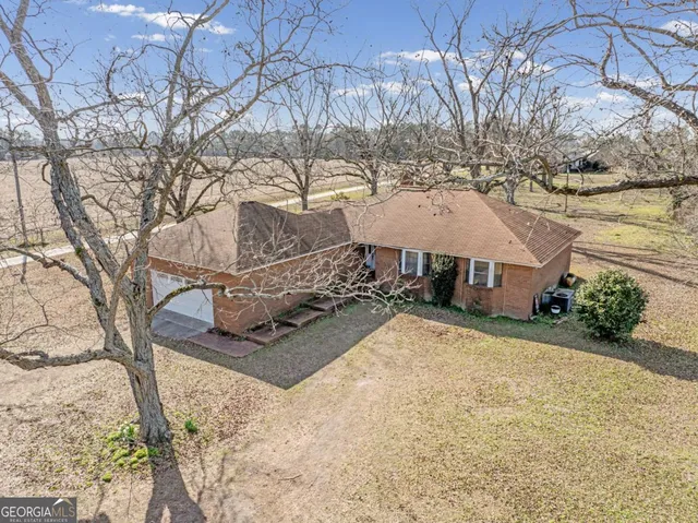 a view of a house with a snow in the yard