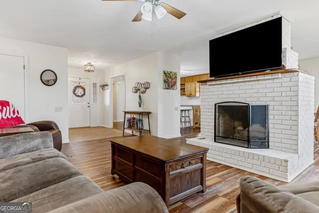 a living room with furniture a flat screen tv and a fireplace