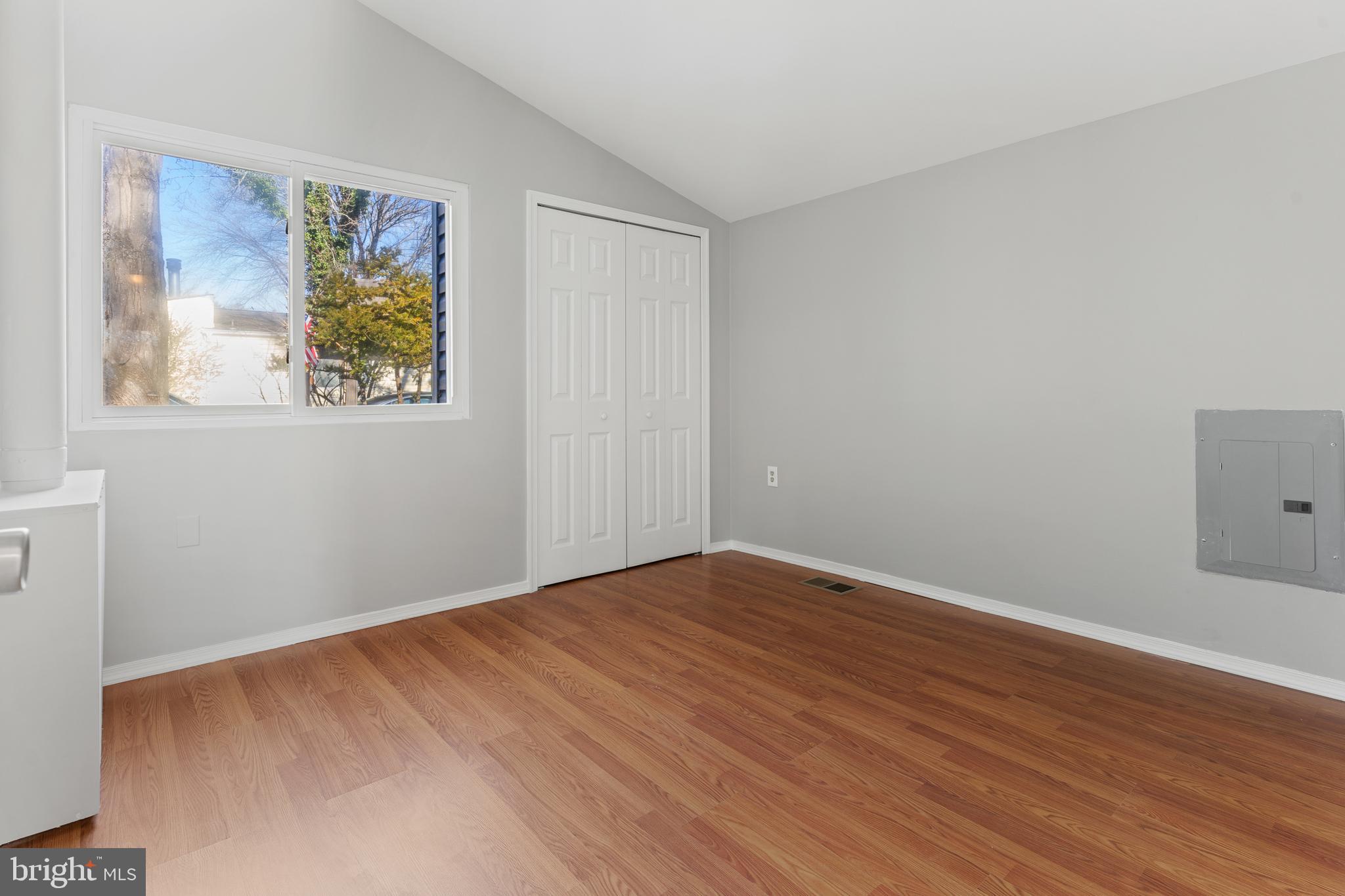 6145 Sinbad Place Columbia, MD 21045 - Photo 12 of 23 a view of an empty room with wooden floor and a window