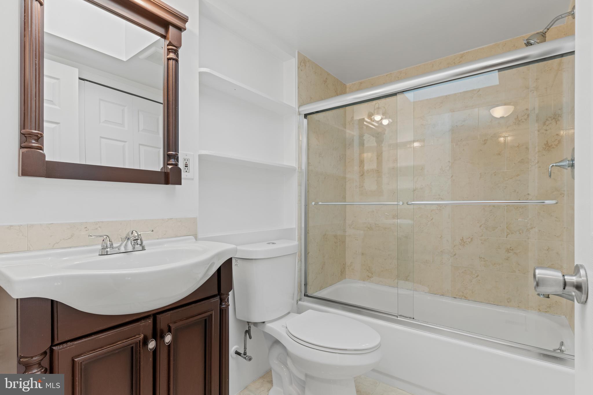 6145 Sinbad Place Columbia, MD 21045 - Photo 14 of 23 a bathroom with a sink toilet and shower