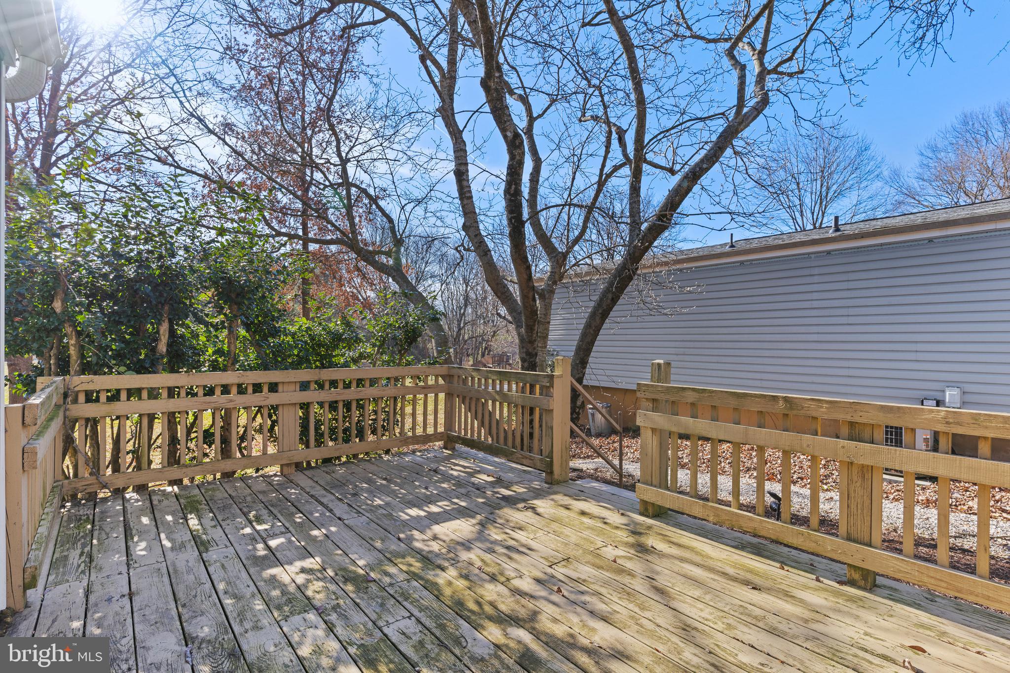 6145 Sinbad Place Columbia, MD 21045 - Photo 20 of 23 a view of a wooden deck with trees