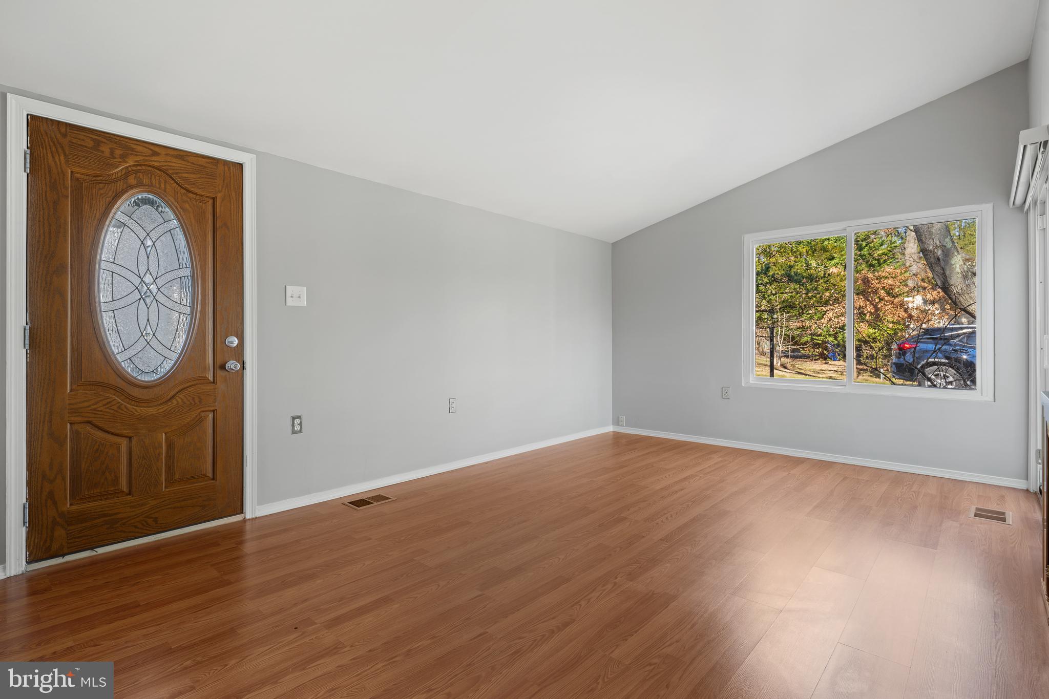 6145 Sinbad Place Columbia, MD 21045 - Photo 5 of 23 an empty room with wooden floor and a window