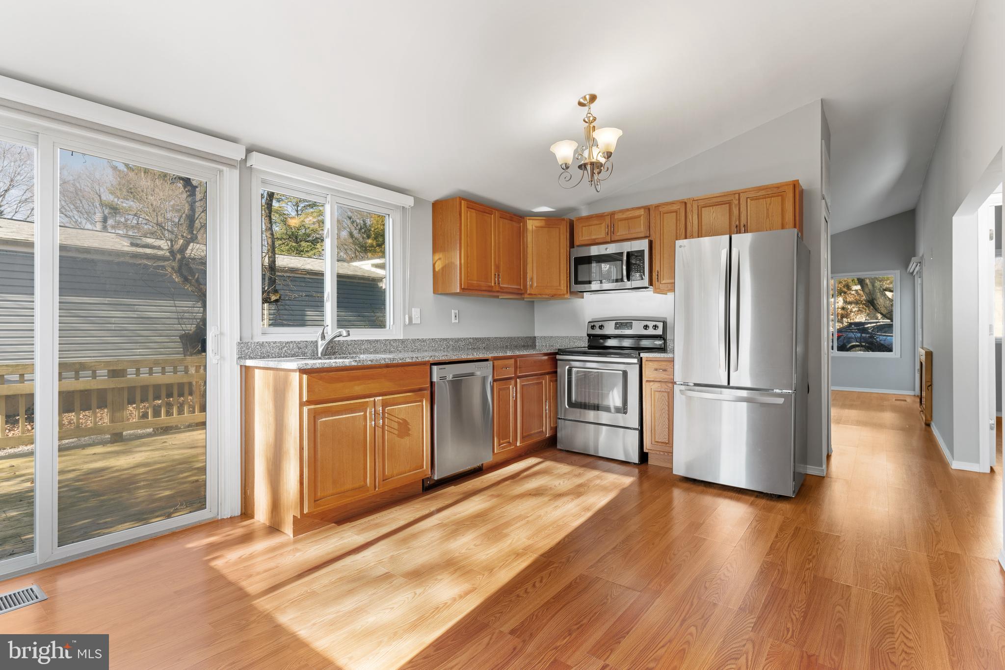 6145 Sinbad Place Columbia, MD 21045 - Photo 9 of 23 a kitchen with stainless steel appliances granite countertop a refrigerator and a stove top oven