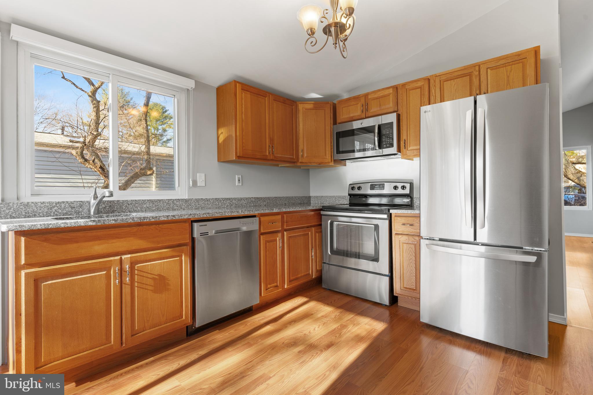 6145 Sinbad Place Columbia, MD 21045 - Photo 10 of 23 a kitchen with stainless steel appliances granite countertop a refrigerator stove top oven and sink