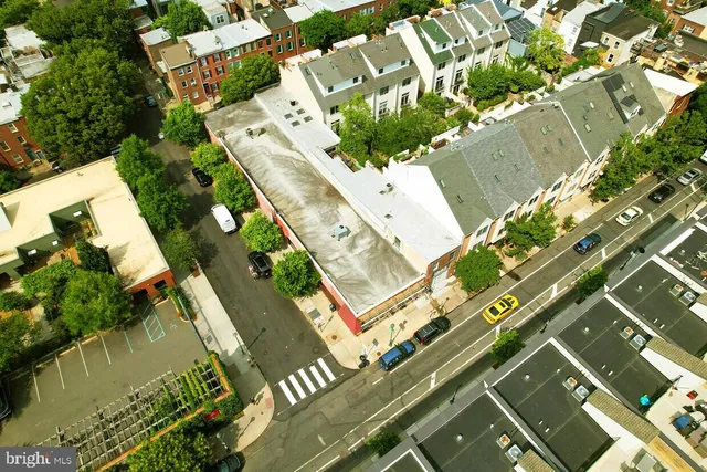 an aerial view of a residential houses with yard