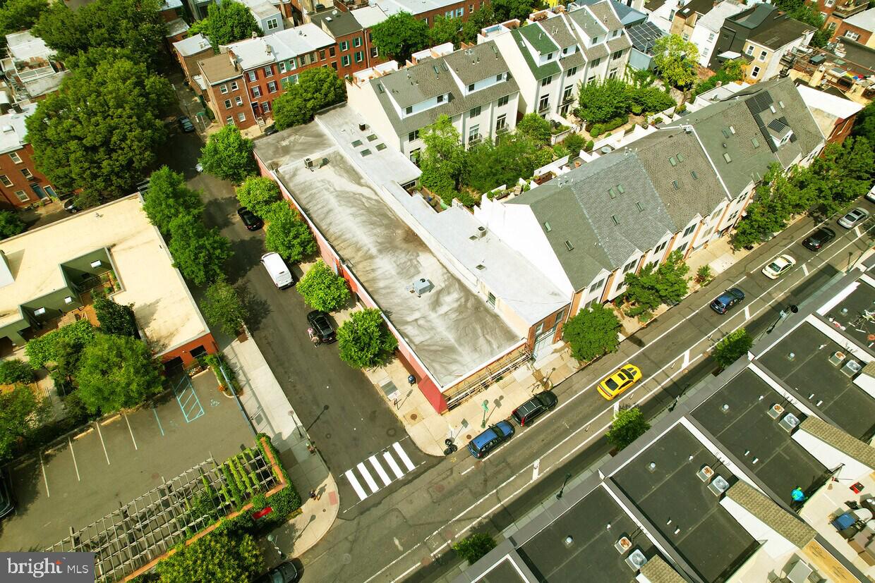 an aerial view of a residential houses with yard