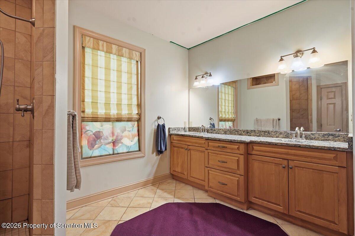 99 Hilltop Road Waverly, PA 18471 - Photo 28 of 41 a spacious bathroom with double vanity a mirror and a bathtub