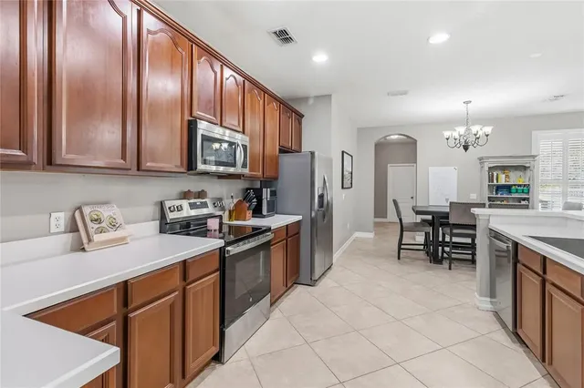 a bathroom with a granite countertop sink a toilet a mirror and a window