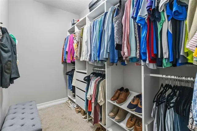 an aerial view of a house with a yard and lake view