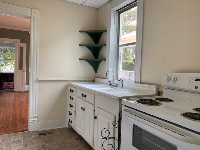 1217 17th Street Columbus, GA 31901 - Photo 11 of 20 a kitchen with a stove and a window