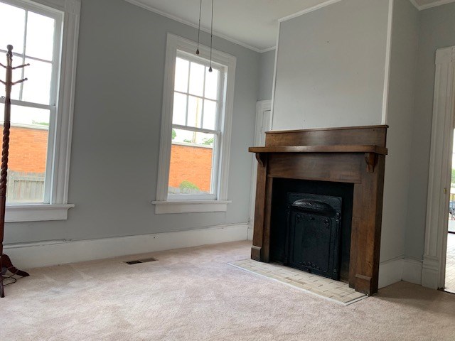 1217 17th Street Columbus, GA 31901 - Photo 14 of 20 an empty room with windows and fireplace