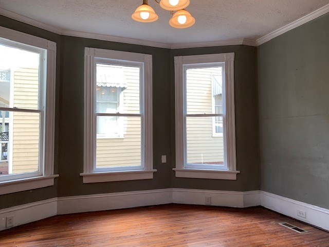 1217 17th Street Columbus, GA 31901 - Photo 5 of 20 a view of empty room with wooden floor and fan