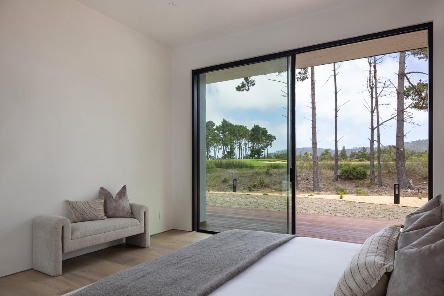 31 Poppy Lane Pebble Beach, CA 93953 - Photo 27 of 51 a living room with a large window and a glass door