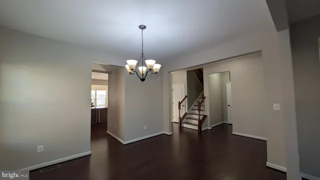 a living room with furniture a flat screen tv and kitchen view