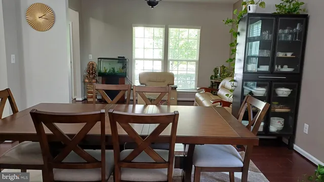a living room with furniture and a ceiling fan