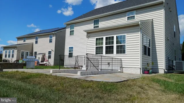 a view of a hallway with a livingroom and a bathroom with a sink