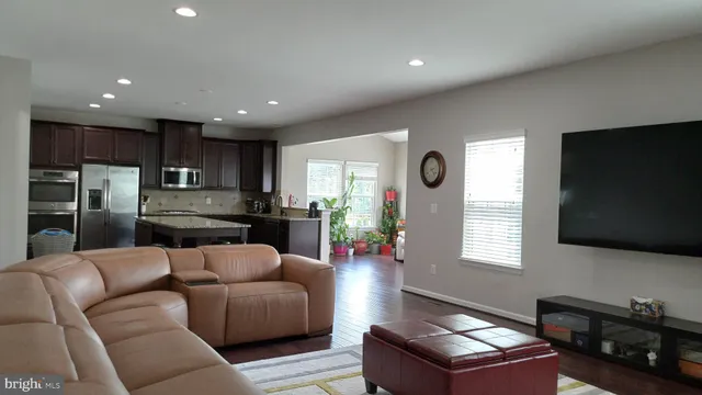 a living room with furniture gym equipment and a large window