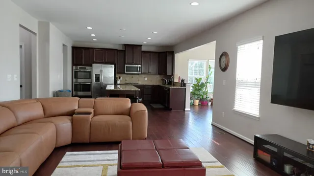 a view of a room that has a window and potted plants