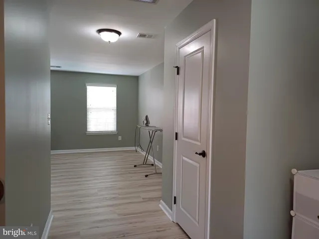 a living room with furniture wooden floor and a flat screen tv