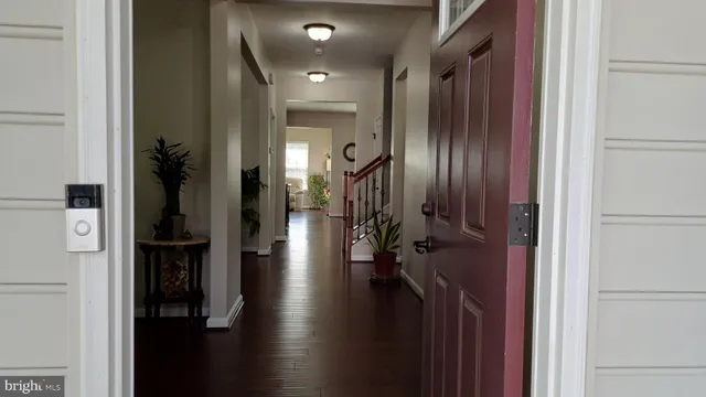 a view of a room with wooden floor and windows