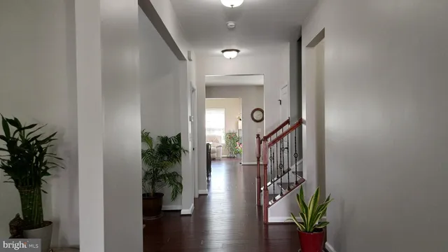 an empty room with wooden floor and staircase