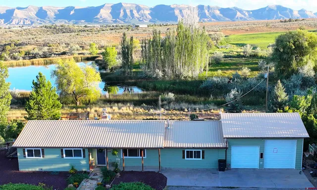 an aerial view of residential houses with outdoor space and river