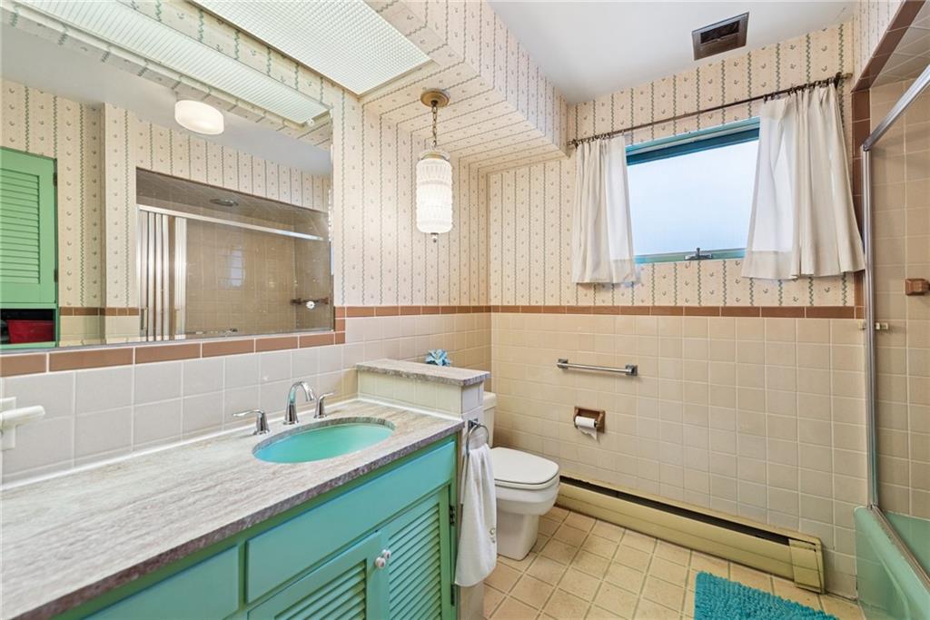 340 Weldon Street Latrobe, PA 15650 - Photo 12 of 26 a bathroom with a granite countertop sink mirror vanity and toilet
