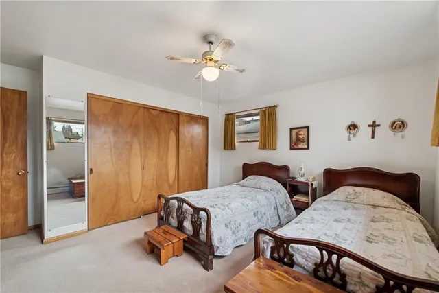 a bedroom with two beds and painted walls