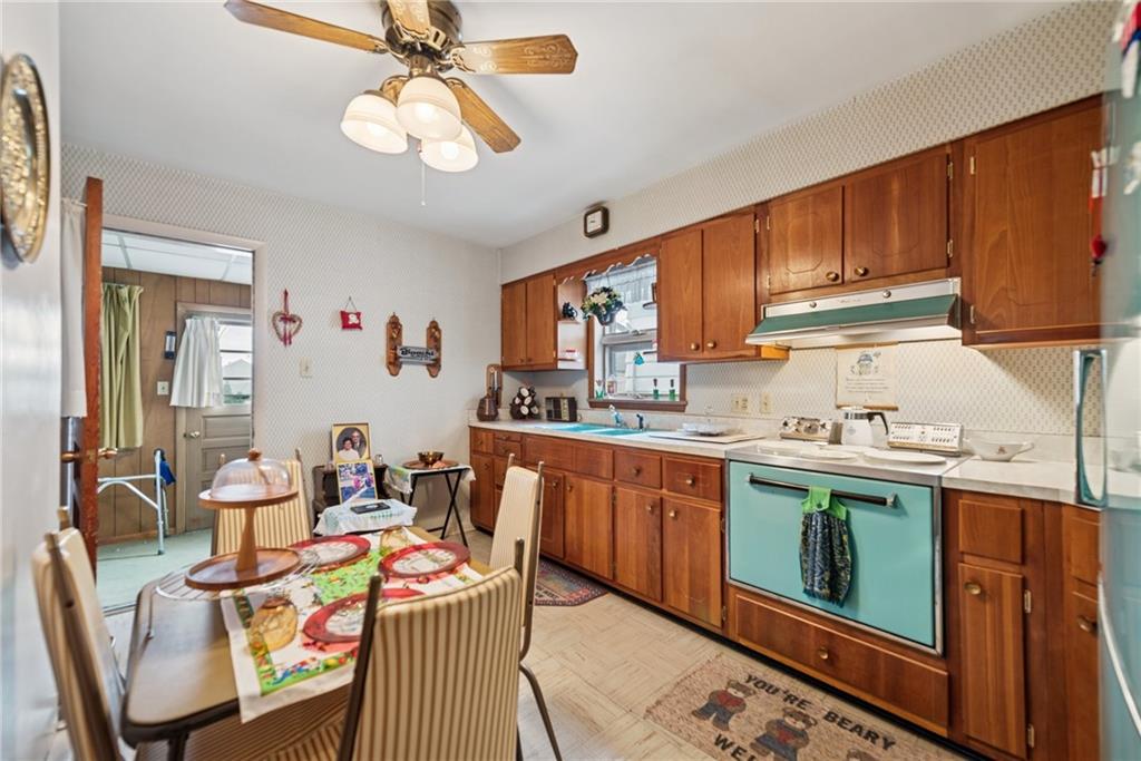 340 Weldon Street Latrobe, PA 15650 - Photo 19 of 26 a open kitchen with stainless steel appliances granite countertop a stove top oven a sink dishwasher and cabinets with wooden floor