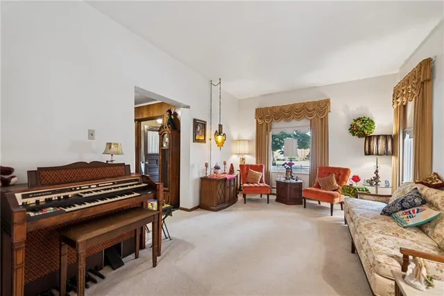 a living room with furniture and a piano