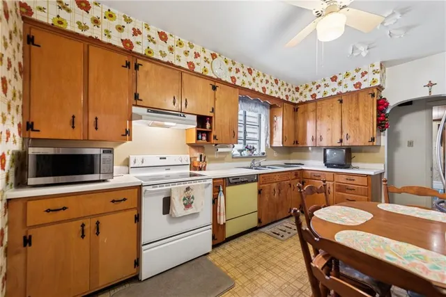 a kitchen with a stove a sink and cabinets