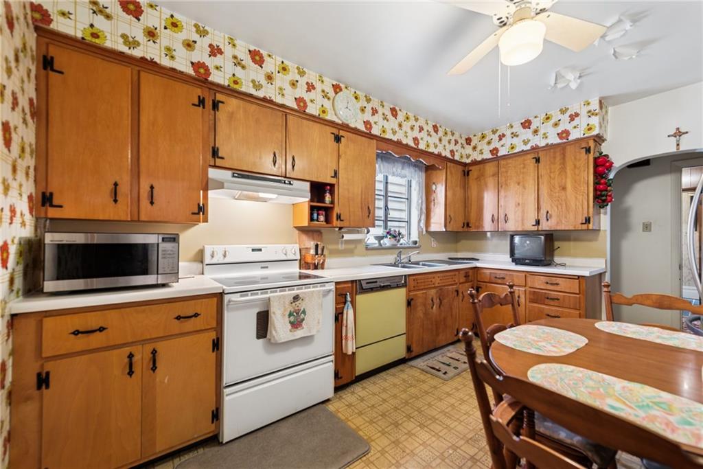 340 Weldon Street Latrobe, PA 15650 - Photo 8 of 26 a kitchen with a stove a sink and cabinets